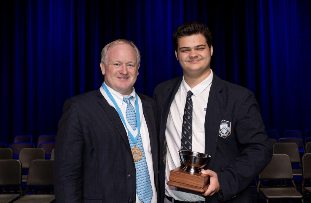 UNSUNG HERO: Collin Cook ’25 poses alongside Upper Division Director Ryan Jordan with the Betty Bruce H. Hoover Award.